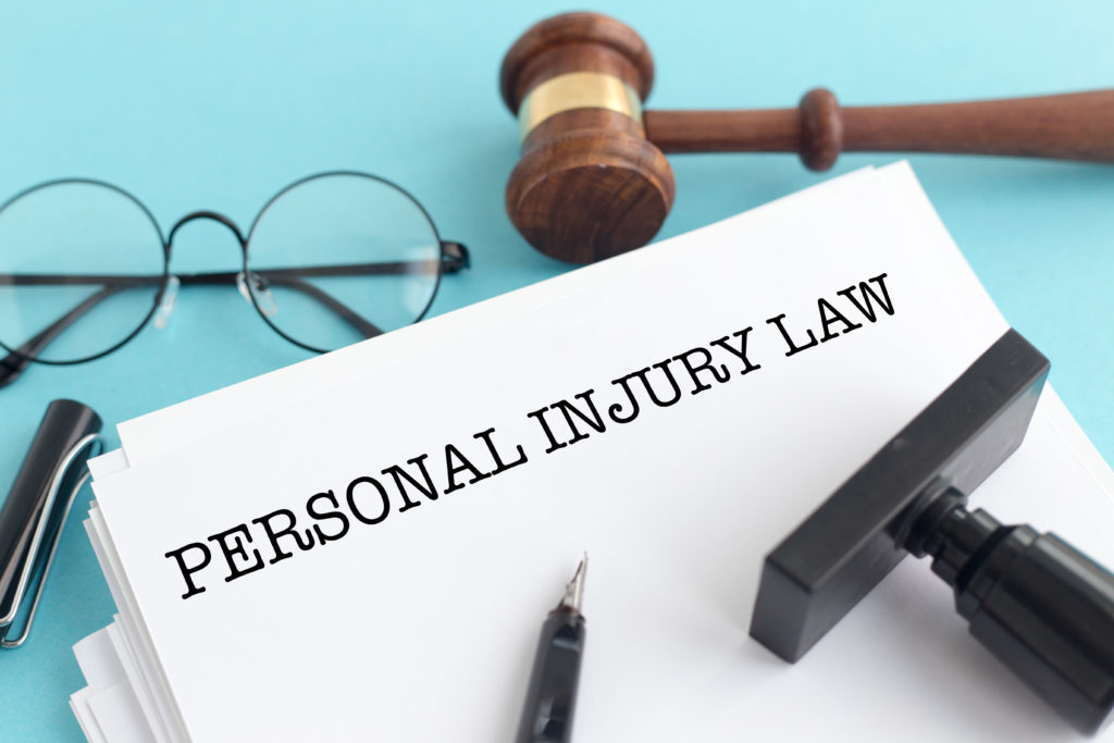 personal injury lawyer Miami FL- document of personal injury law with gavel and glasses 